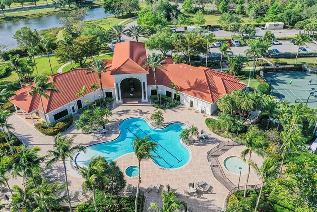 an aerial view of a house with yard swimming pool and outdoor seating