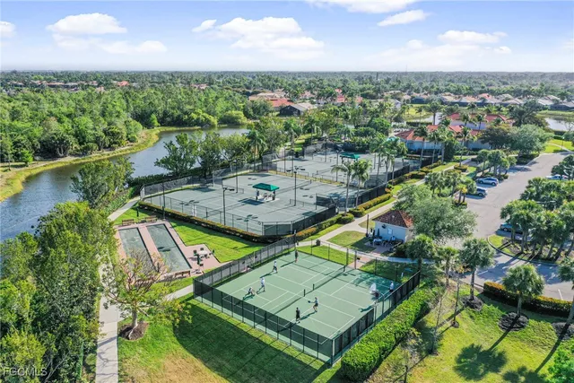 an aerial view of a house with a garden and lake view