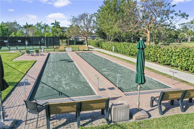 a view of a swimming pool with a patio and a yard