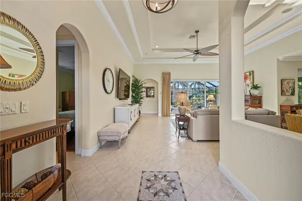 a living room with furniture a fireplace and a chandelier