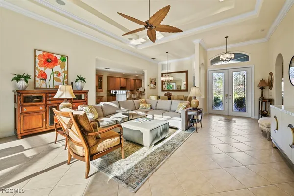 a living room with furniture a flat screen tv and kitchen view