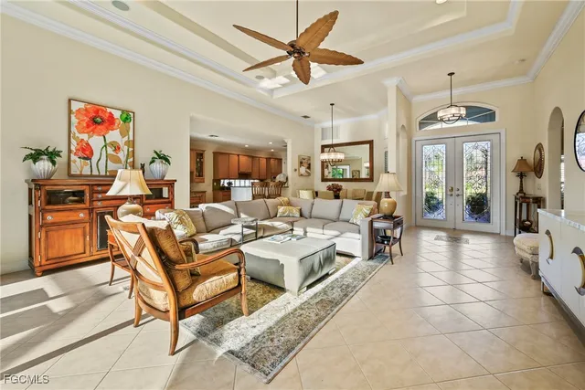 a living room with furniture a flat screen tv and kitchen view