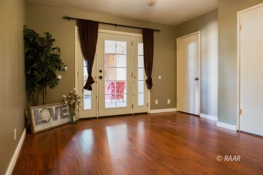 712 West Wilson Avenue Ridgecrest, CA 93555 - Photo 14 of 18 a view of an empty room with wooden floor and a window