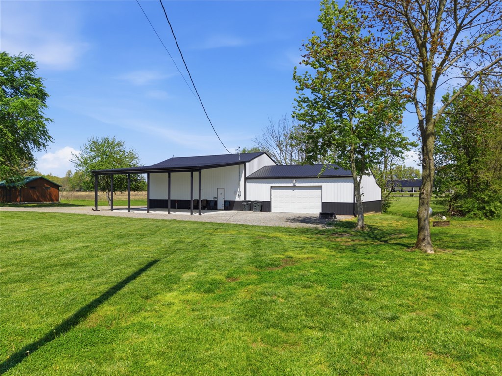 1602 Westboro Road Blanchester, OH 45107 - Photo 71 of 81 This spacious property offers a practical garage and an expansive, verdant lawn, ideal for outdoor pursuits.
