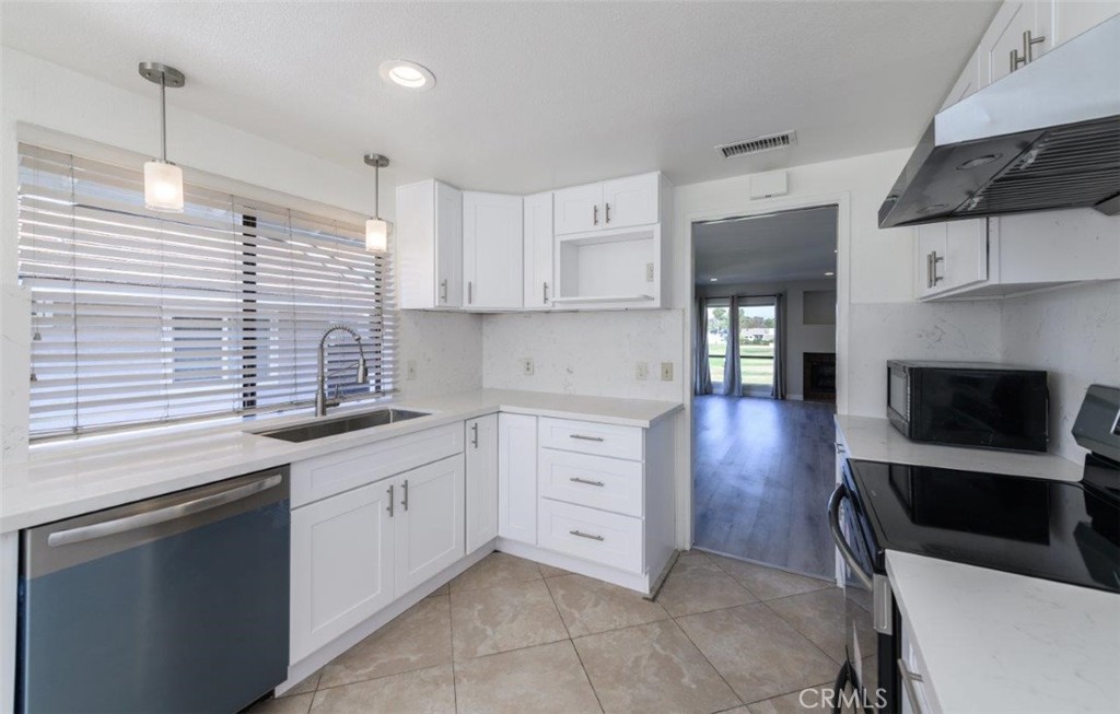 42 Lakeview Irvine, CA 92604 - Photo 12 of 46 a kitchen with granite countertop a sink a stove and cabinets