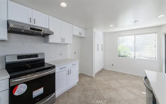 a kitchen with granite countertop a stove and a sink