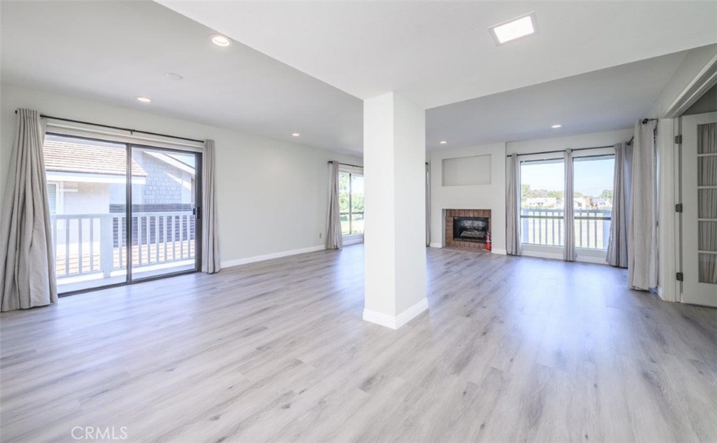 42 Lakeview Irvine, CA 92604 - Photo 2 of 46 an empty room with wooden floor and a fireplace