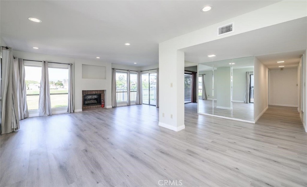 42 Lakeview Irvine, CA 92604 - Photo 3 of 46 an empty room with wooden floor and a fireplace