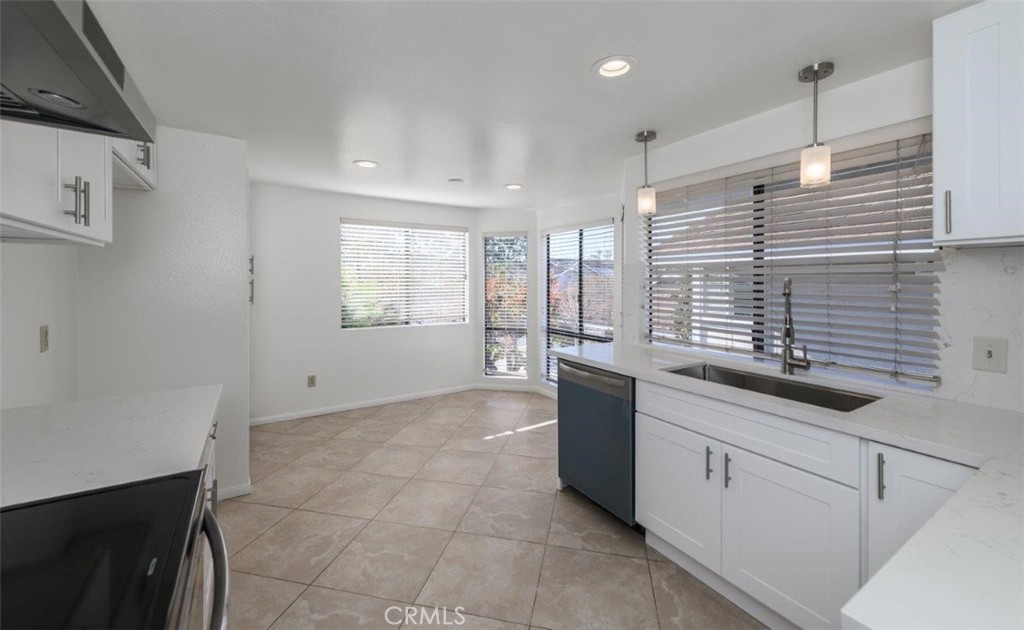 42 Lakeview Irvine, CA 92604 - Photo 10 of 46 a large white kitchen with sink and window
