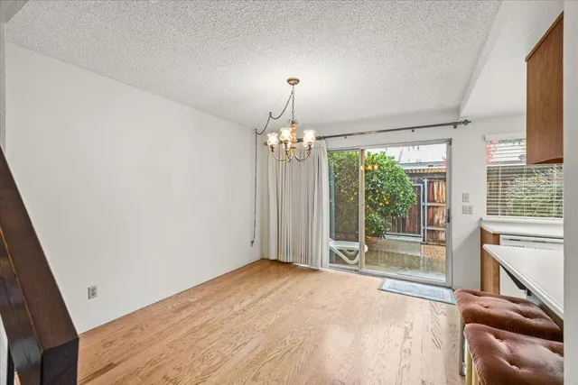 a kitchen with kitchen island a large window a sink and cabinets