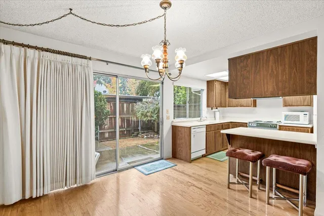 a kitchen with stainless steel appliances granite countertop a sink a stove and a refrigerator