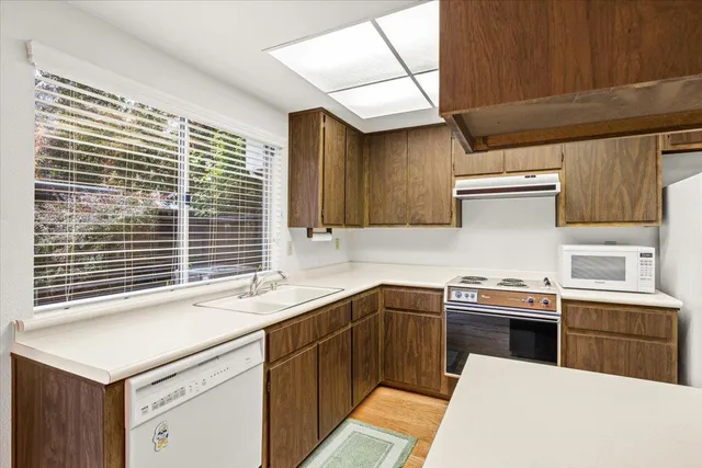 a kitchen with a stove sink and refrigerator