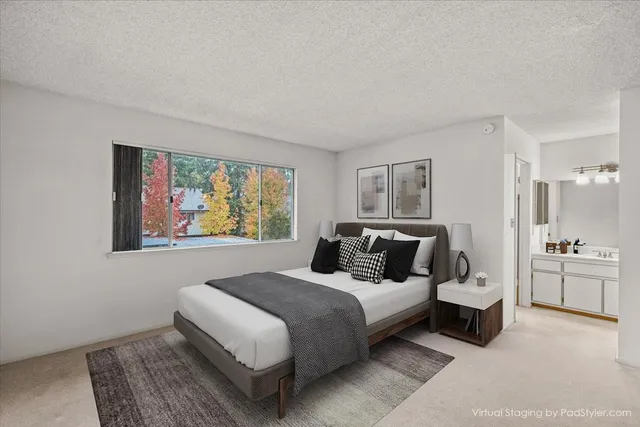 a bedroom with a bed and glass windows