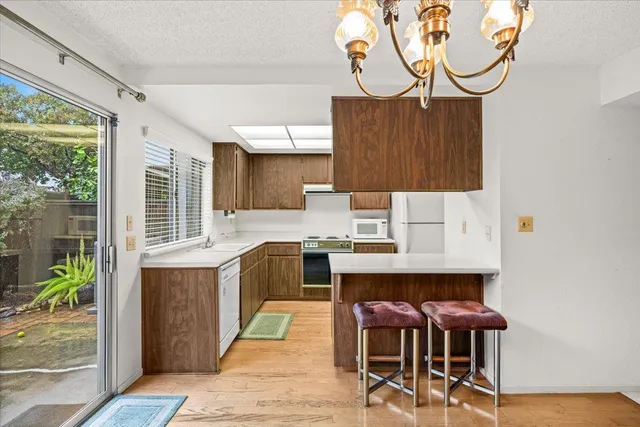 a kitchen with a table chairs and a window