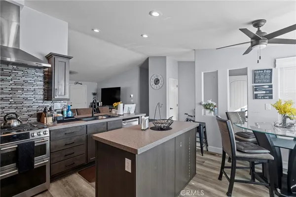 a kitchen with stainless steel appliances a sink stove and cabinets