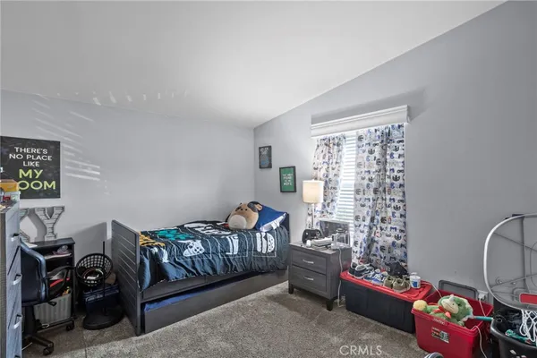a bedroom with a bed and window
