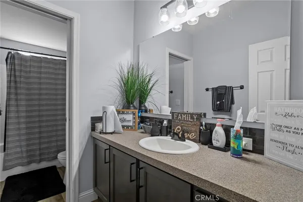 a bathroom with a double vanity sink and a mirror