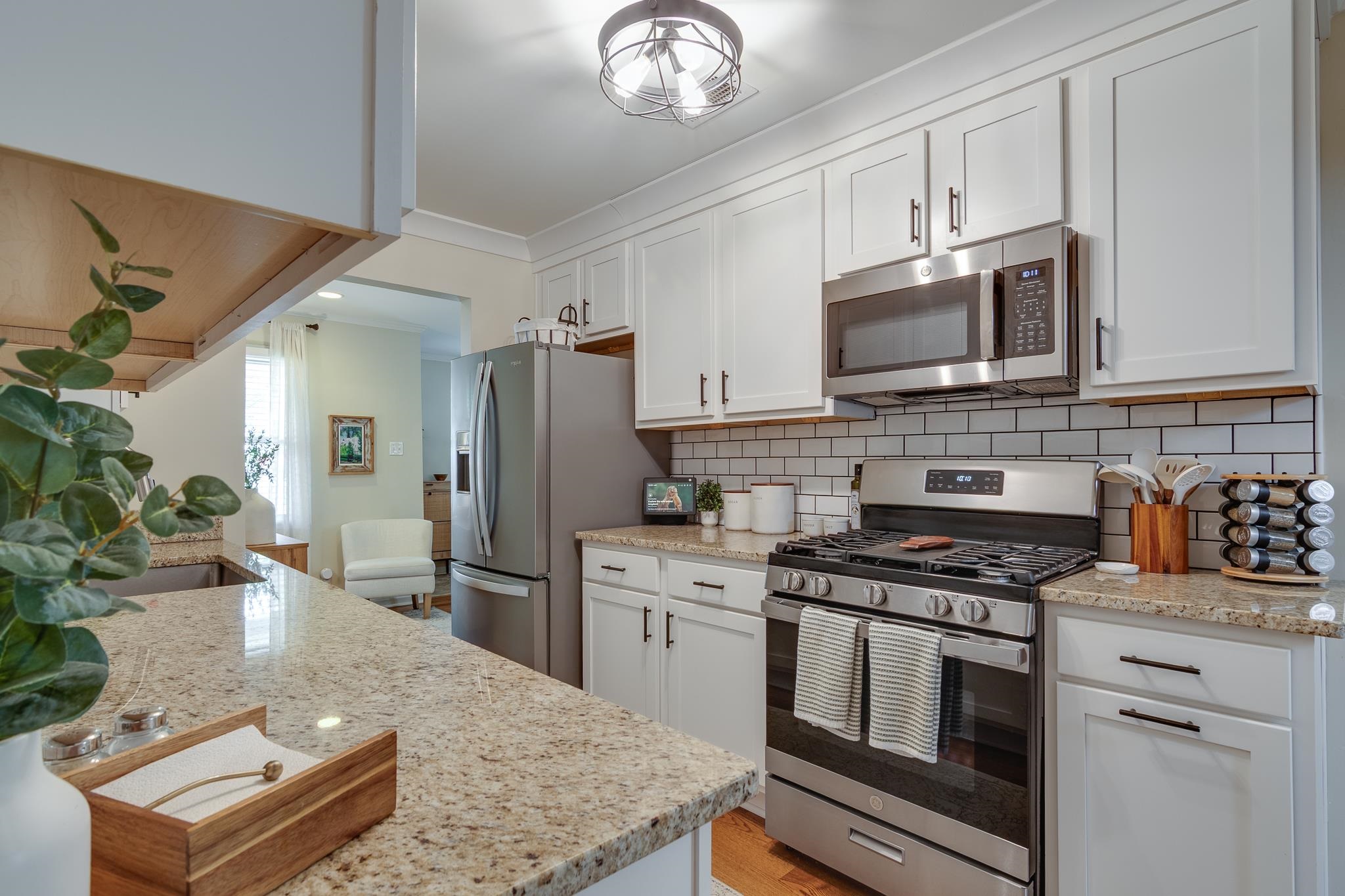 4961 Sea Isle Road Memphis, TN 38117 - Photo 11 of 29 Kitchen featuring tasteful backsplash, white cabinetry, and stainless steel appliances