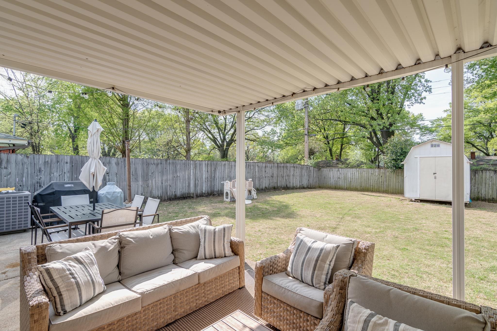 4961 Sea Isle Road Memphis, TN 38117 - Photo 24 of 29 View of patio / terrace featuring a storage shed, a fenced backyard, an outdoor hangout area, and an outbuilding