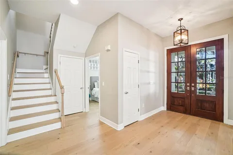 a view of a dining room with furniture wooden floor and a chandelier