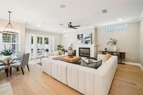 a room with stainless steel appliances granite countertop furniture and a chandelier