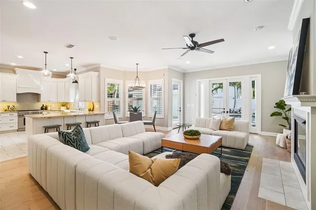a kitchen with stainless steel appliances granite countertop a sink a stove and a white cabinets