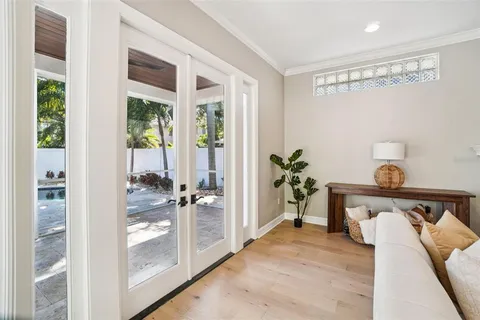 a kitchen with a sink dishwasher a stove and white cabinets with wooden floor