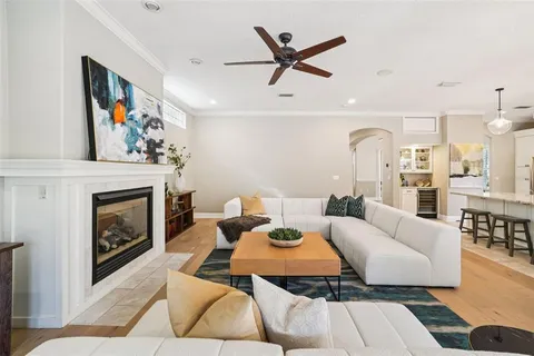 a kitchen with stainless steel appliances kitchen island granite countertop a table chairs and a refrigerator