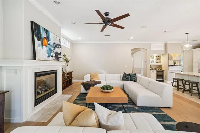 a kitchen with stainless steel appliances kitchen island granite countertop a table chairs and a refrigerator