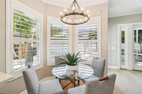 a view of a hallway with wooden floor and a living room