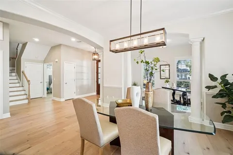a bathroom with a granite countertop sink a mirror and a potted plant
