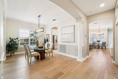 a view of staircase with lots of frames on wall and a large window
