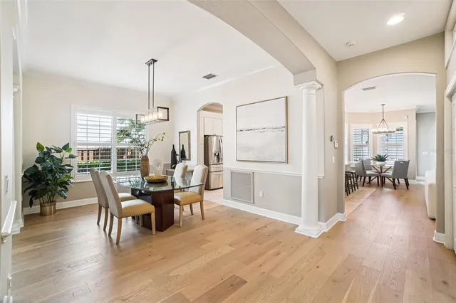 a view of staircase with lots of frames on wall and a large window