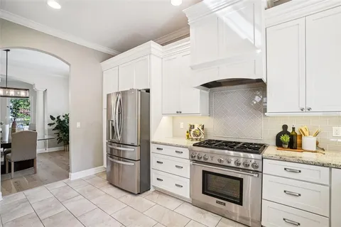 a bathroom with a granite countertop sink toilet and mirror