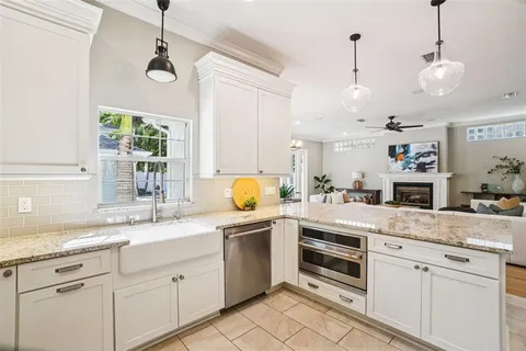 a view of a hallway with wooden floor and a bathroom