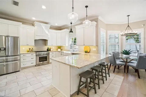 a bathroom with a granite countertop sink a mirror a vanity and a bathtub