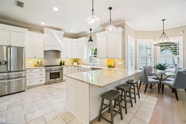 a bathroom with a granite countertop sink a mirror a vanity and a bathtub
