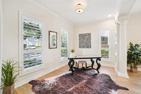 a bathroom with a granite countertop tub a double vanity sink a mirror a shower and a window