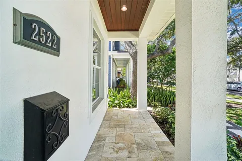 a living room with furniture fireplace and a large window