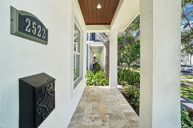 a living room with furniture fireplace and a large window