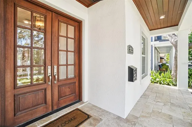 a living room with furniture kitchen view and a large window
