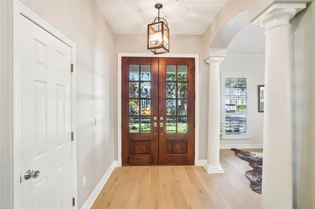 a view of a dining room with furniture wooden floor and a chandelier