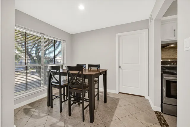 a view of a dining room with furniture and window