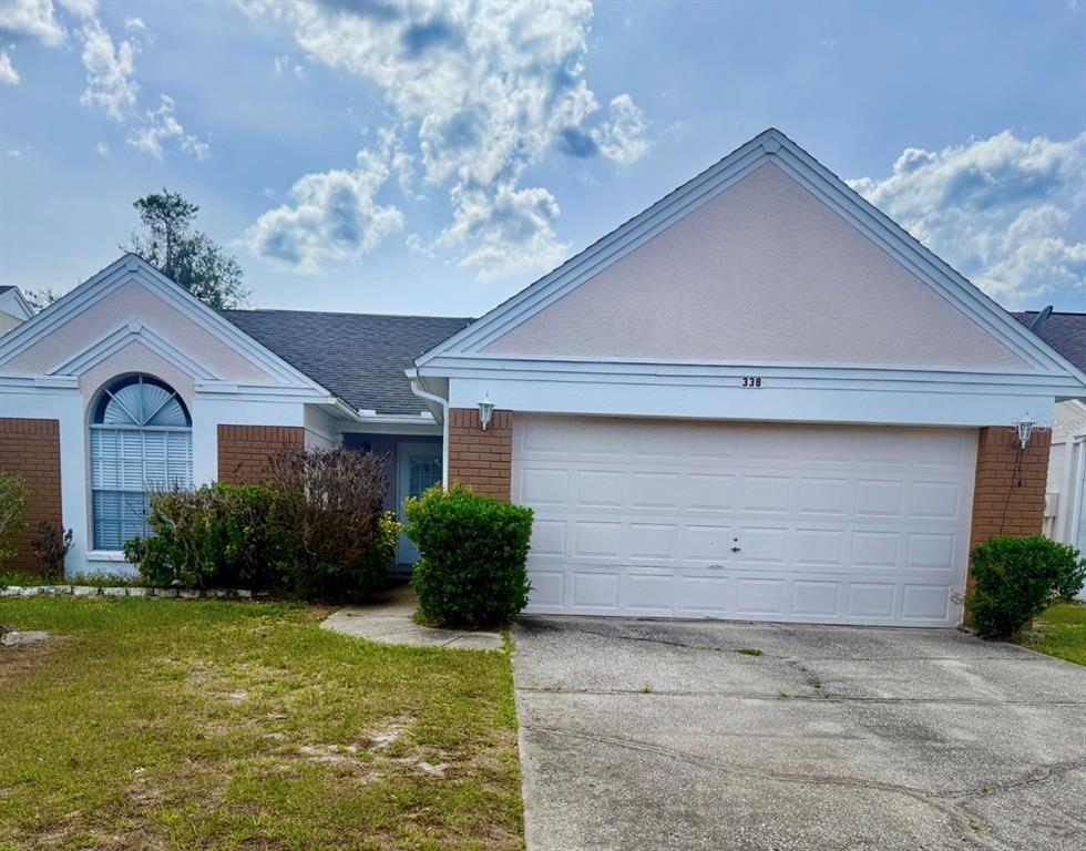 338 Mantis Loop Apopka, FL 32703 - Photo 1 of 11 a front view of a house with garden