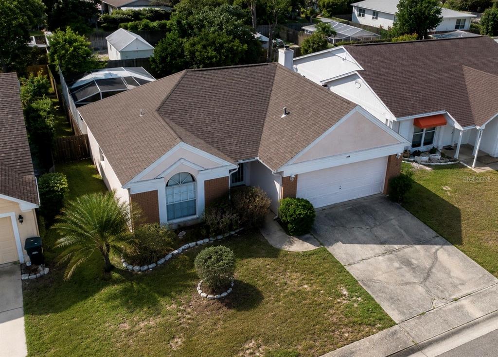 338 Mantis Loop Apopka, FL 32703 - Photo 3 of 11 a aerial view of a house with a yard and large tree