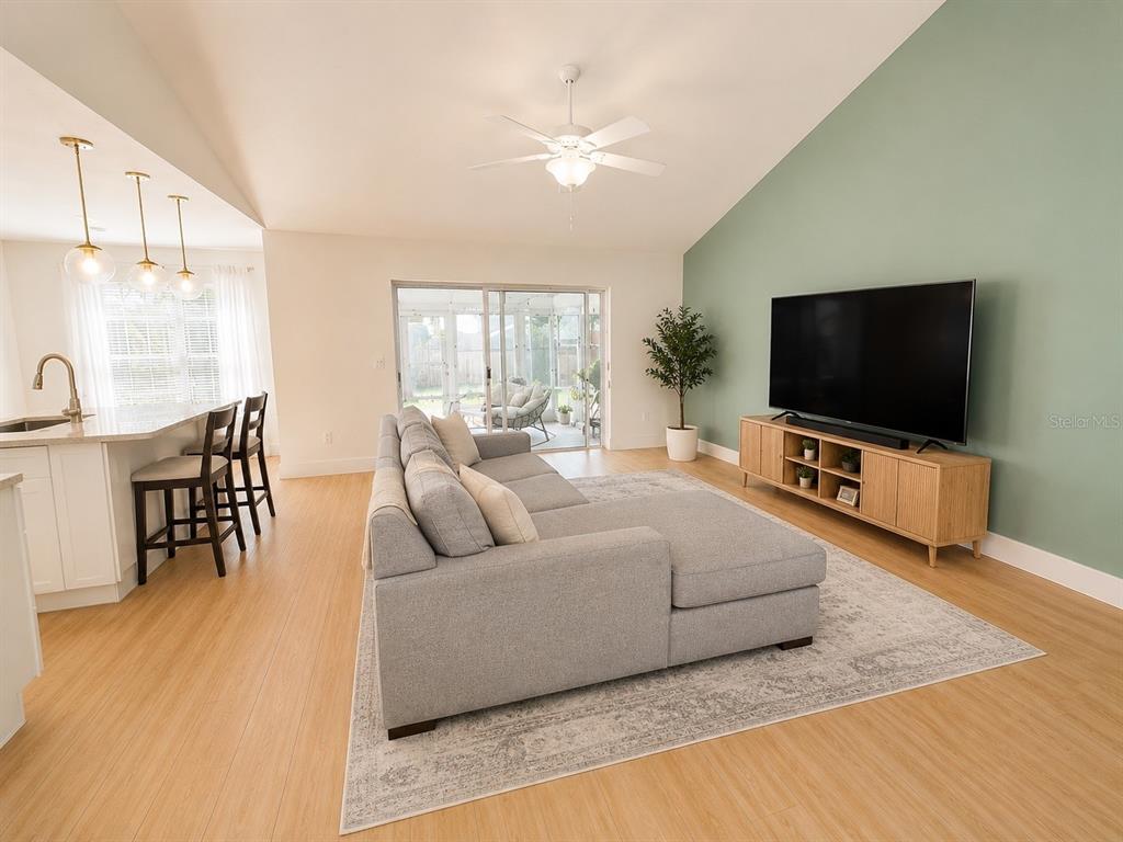 338 Mantis Loop Apopka, FL 32703 - Photo 6 of 11 a living room with furniture and a flat screen tv