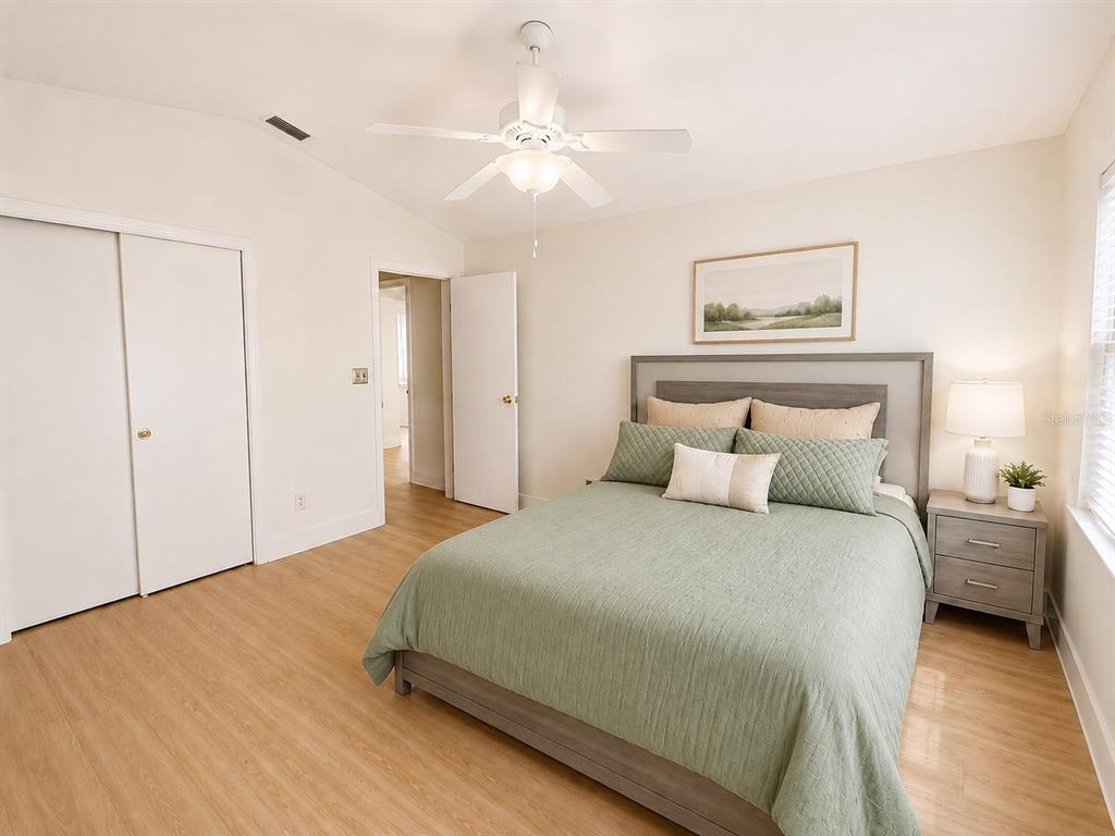 338 Mantis Loop Apopka, FL 32703 - Photo 7 of 11 a bedroom with a bed and a chandelier
