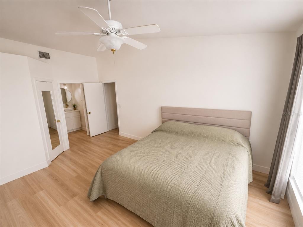338 Mantis Loop Apopka, FL 32703 - Photo 9 of 11 a bedroom with a bed and a ceiling fan