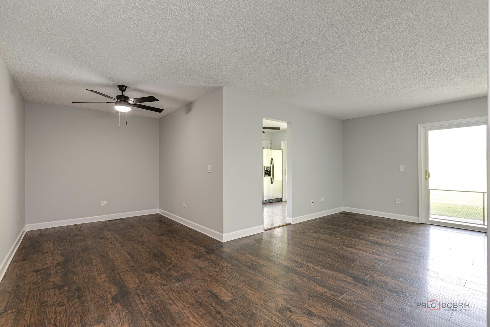 666 Weidner Road Buffalo Grove, IL 60089 - Photo 8 of 25 a view of an empty room with a window and wooden floor