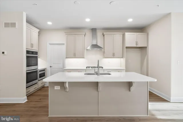 a kitchen with white cabinets a sink and white appliances